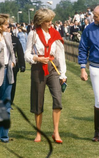 Princess Diana wore capri pants and a white blouse with a red sweater over her shoulders