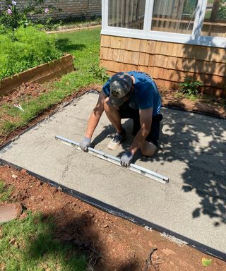 Levelling paver sand as part of laying a patio