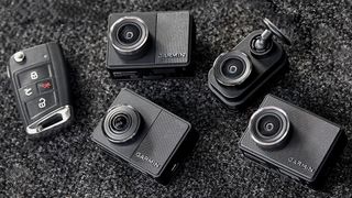 Four mini Garmin dash cams next to some car keys