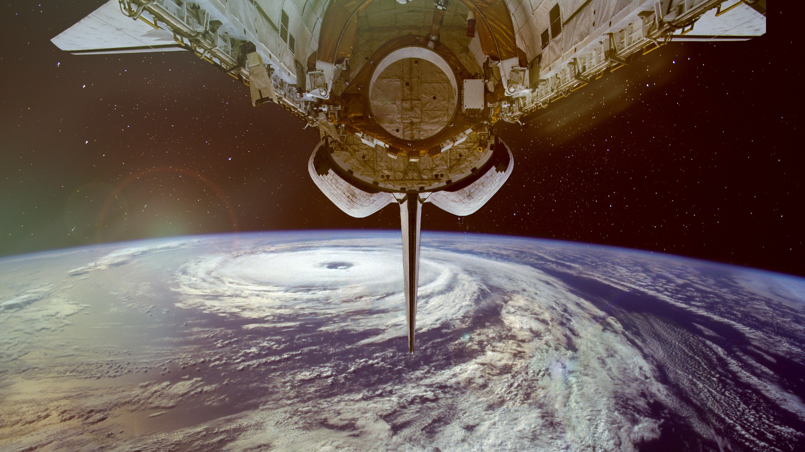 A composite image of a NASA spacecraft orbiting over a typhoon. The U.S. Air Force has announced for the first time that America has weapons of some sort stationed in space.