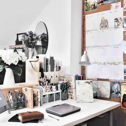 home office area with office table and pin board