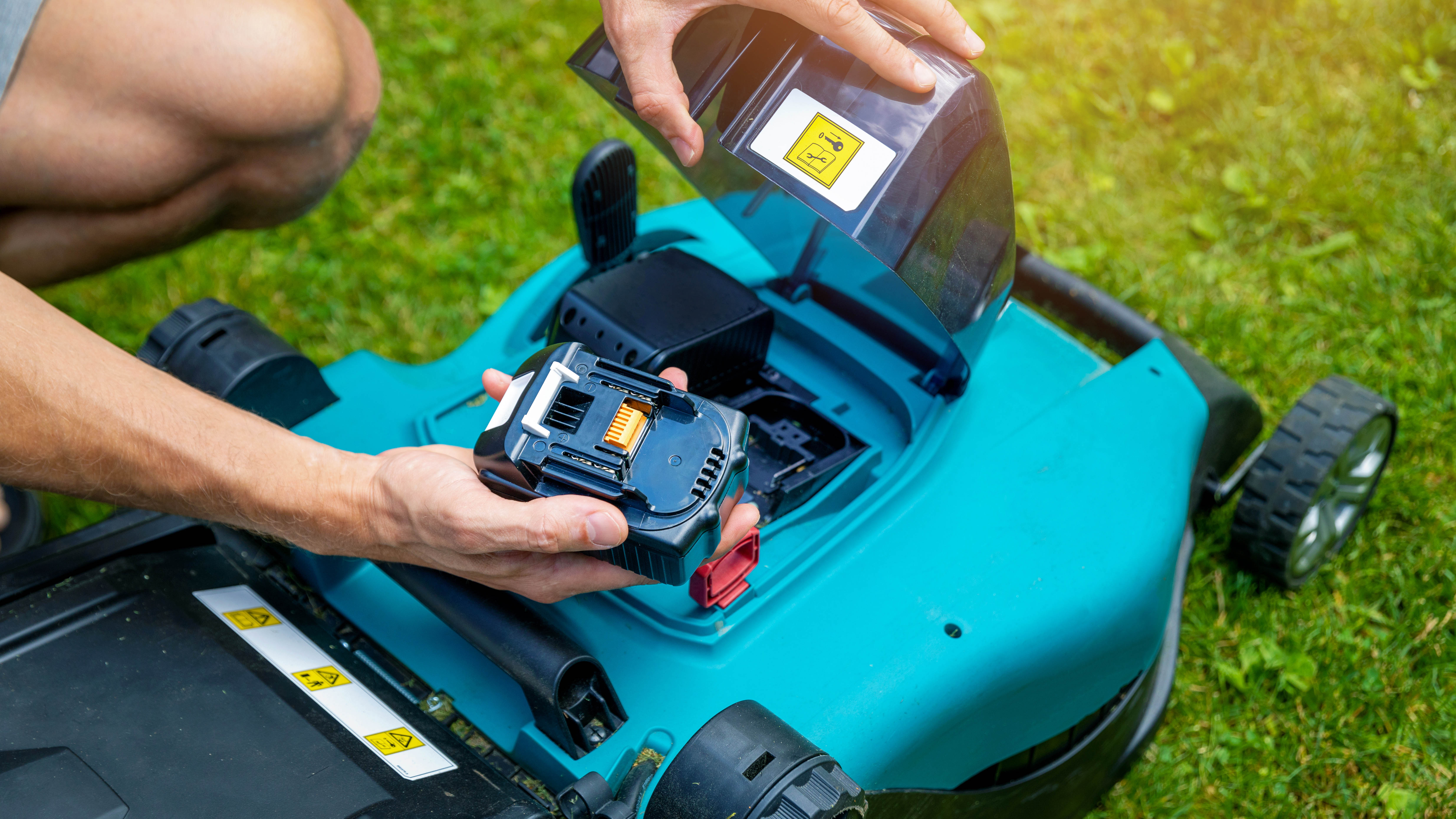Removing battery from cordless lawn mower