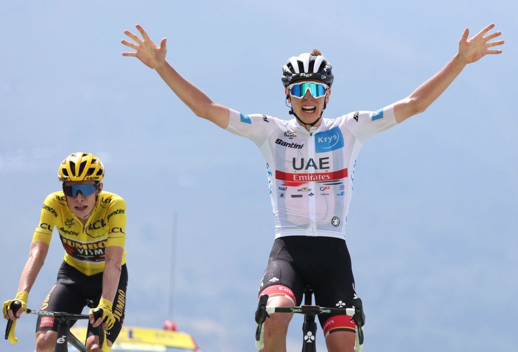 TOPSHOT UAE Team Emirates teams Slovenian rider Tadej Pogacar R wearing the best young riders white jersey celebrates as he cycles to the finish line ahead of JumboVisma teams Danish rider Jonas Vingegaard L wearing the overall leaders yellow jersey to win the 17th stage of the 109th edition of the Tour de France cycling race 1297 km between SaintGaudens and Peyragudes in southwestern France on July 20 2022 Photo by Thomas SAMSON AFP Photo by THOMAS SAMSONAFP via Getty Images