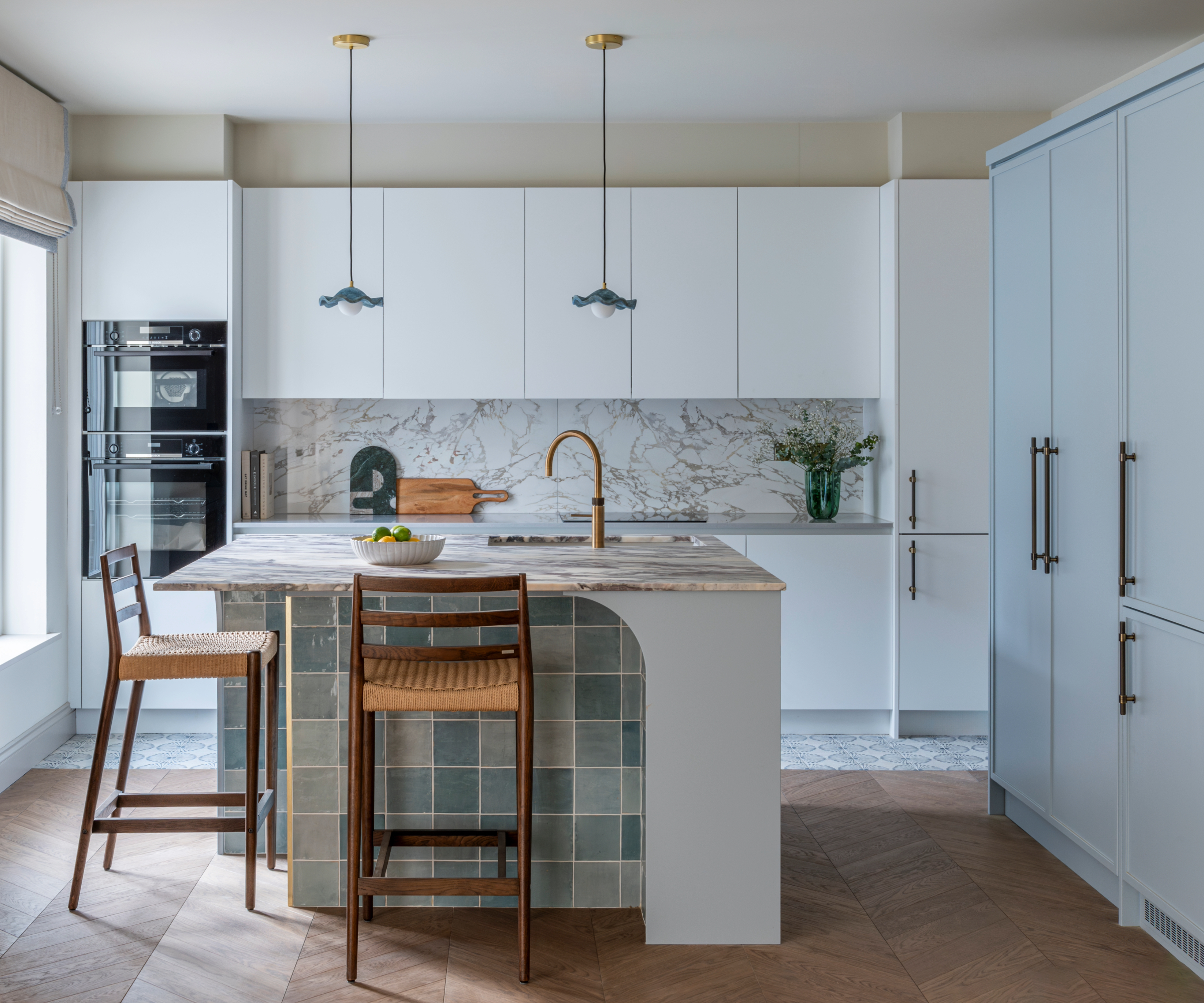 Kitchen with blue and white cabinets and a tiled blue island
