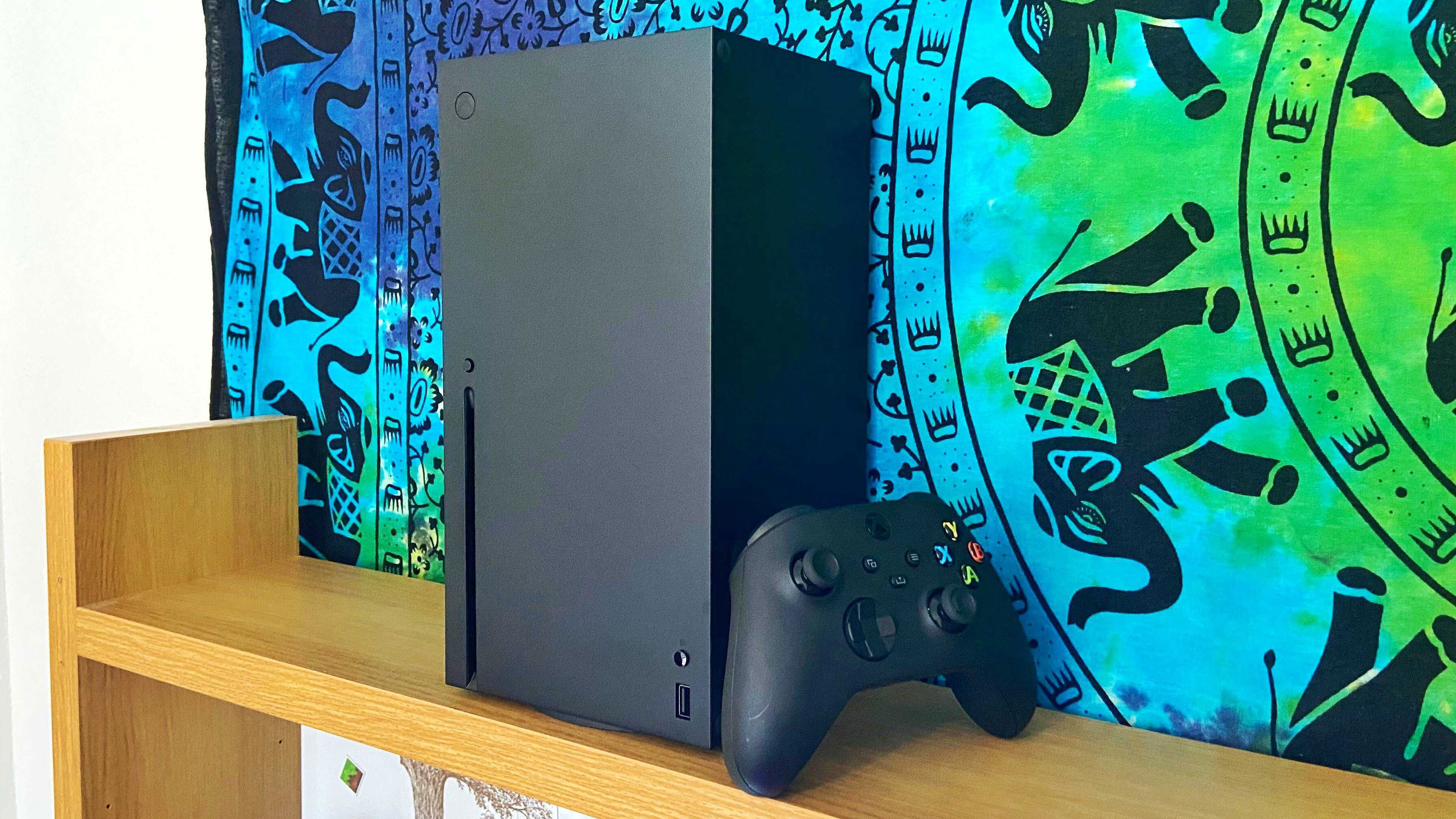 Xbox Series X console with controller and colourful background