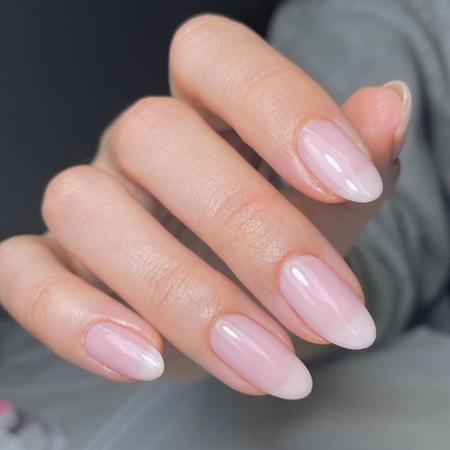 A woman wearing the soap nails manicure trend 