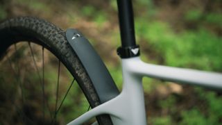 YT Szepter integrated mudguard against a woodland floor background