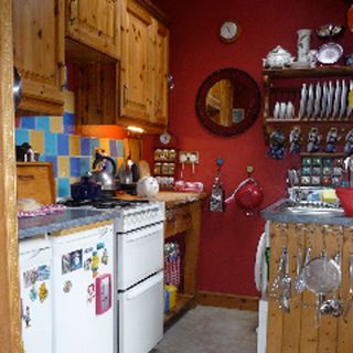 kitchen with red wall and mirror