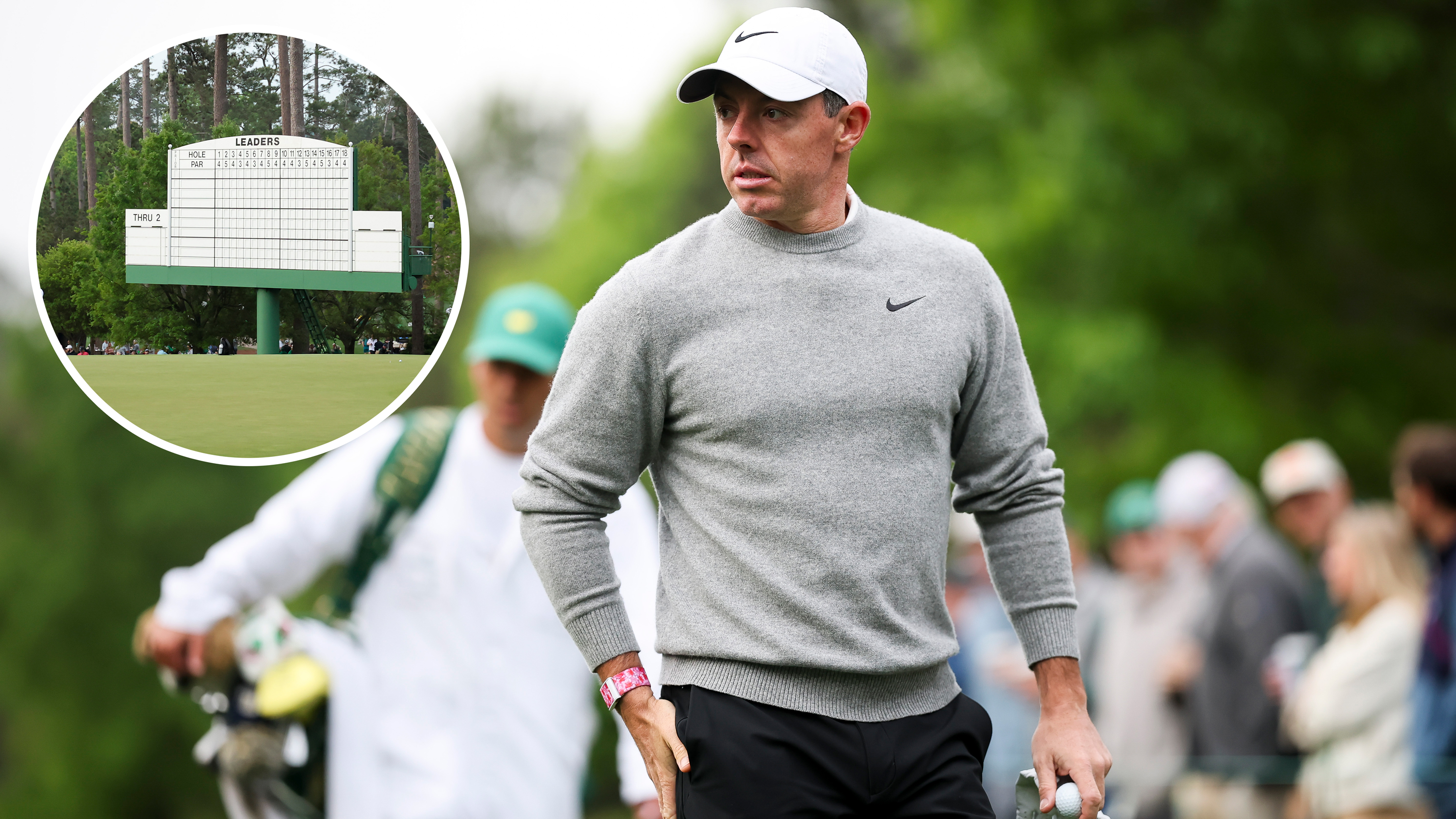 Rory McIlroy at the Masters, appearing to look over at a famous Masters leaderboard at Augusta National