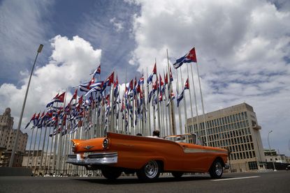 A car drives by the U.S. embassy in Cuba.
