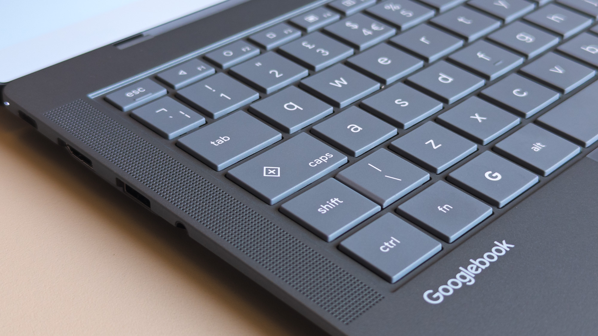 ASUS Googlebook 14 keyboard close up showing caps key with plus symbol