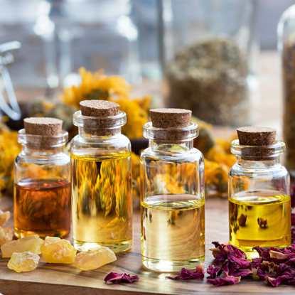 dried roses and bottles on a table