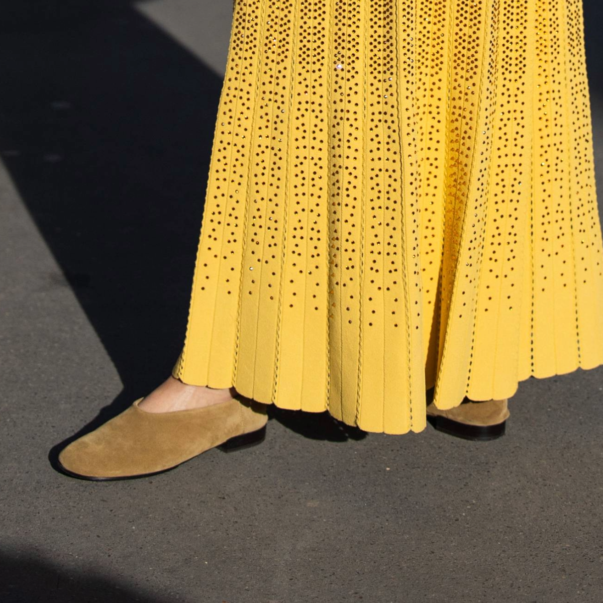 woman wearing yellow dress and suede flats. 