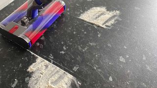 Dyson Omni-glide review: image of vacuuming up flour