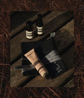 Aesop and raeburn roll-up next to aesop product in brown bottle