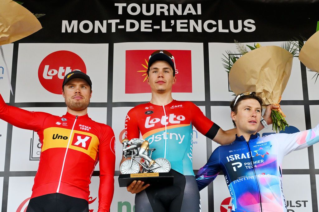 MONTDELENCLUS BELGIUM SEPTEMBER 28 LR Rasmus Tiller of Norway and UnoX Pro Cycling Team on second place race winner Arnaud De Lie of Belgium and Team Lotto Dstny and Corbin Strong of New Zealand and Team IsraelPremier Tech on third place pose on the podium ceremony after the 82nd Circuit FrancoBelge 2023 a 1906km one day race from Tournai to MontdelEnclus on September 28 2023 in MontdelEnclus Belgium Photo by Luc ClaessenGetty Images