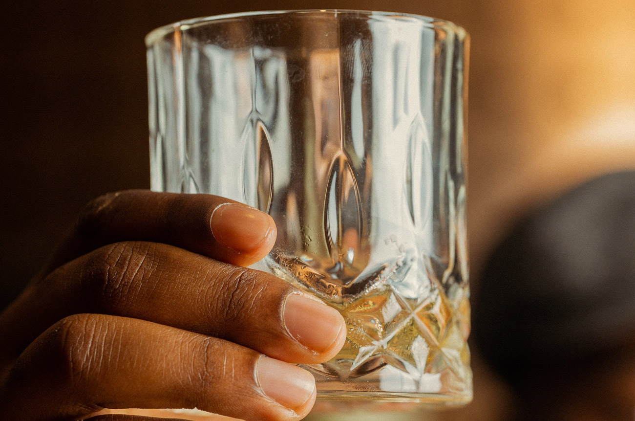a hand holding a glass