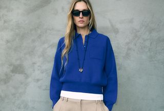 Woman in cerulean blue sweater and beige pants