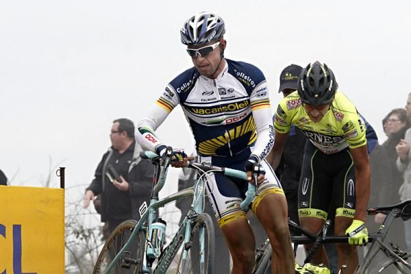 Stijn Devolder and Filippo Pozzato pick themselves up after crashing on the cobbles.