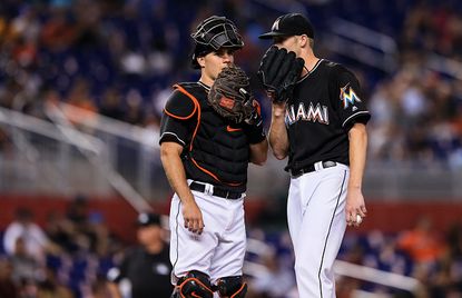 Marlins catcher J.T. Realmuto speaks with pitcher Adam Conley on the mound.
