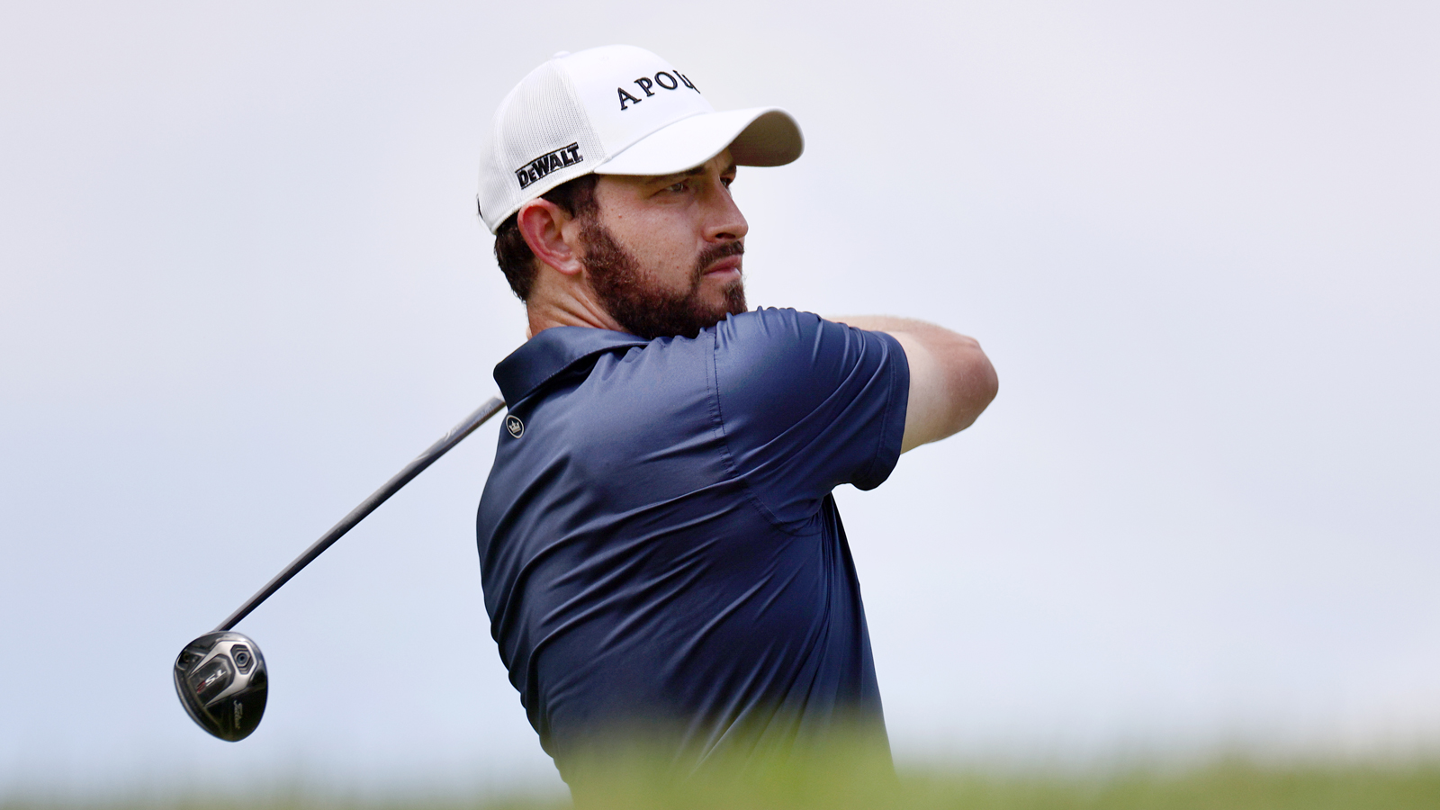 Patrick Cantlay hits a shot and watches it in the air