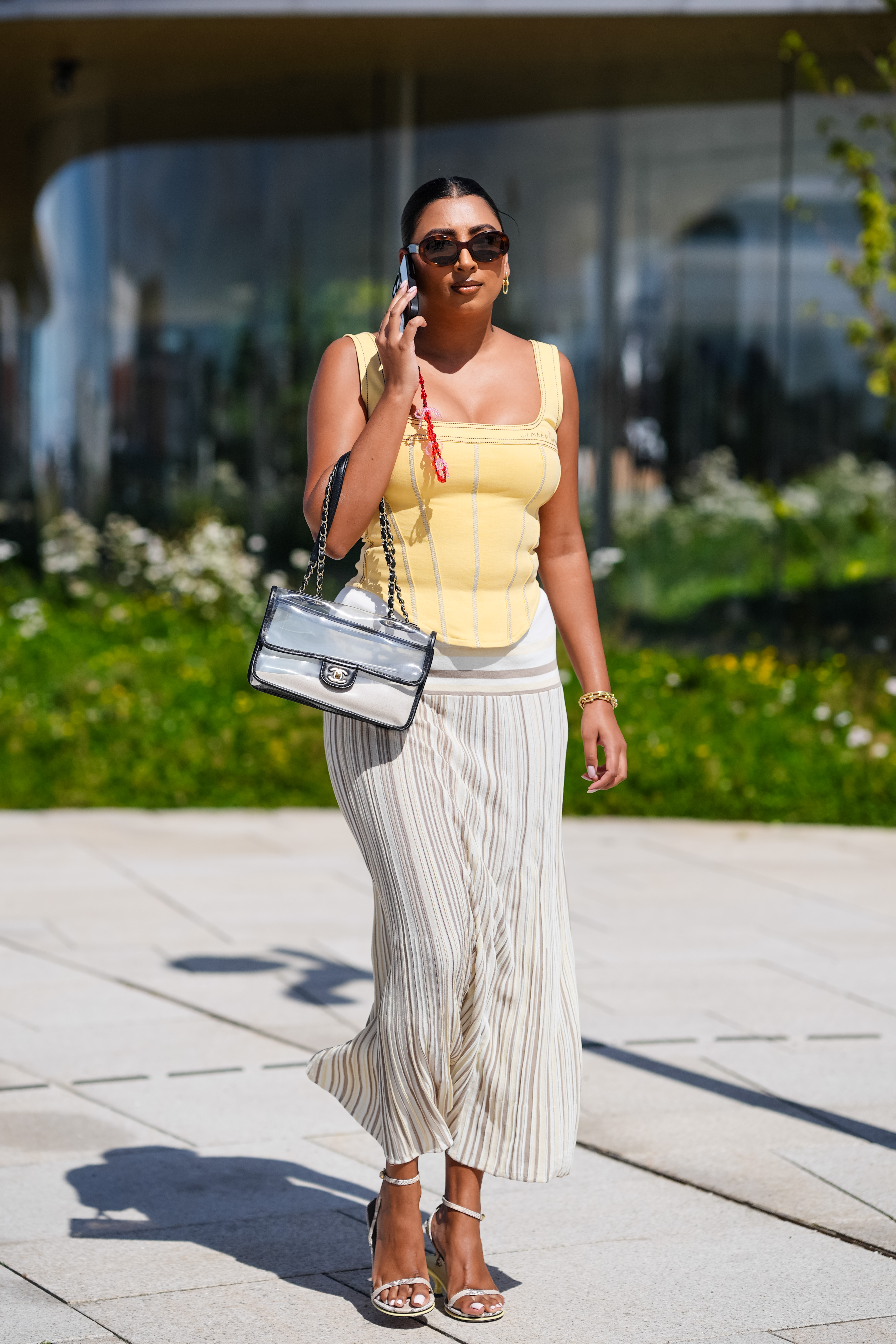 woman wearing yellow top and white skirt