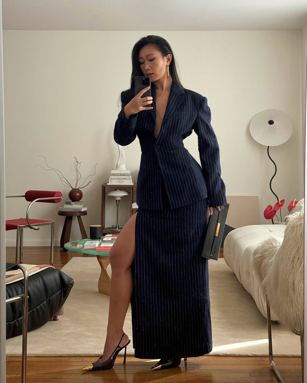 Caroline wearing navy skirt suit