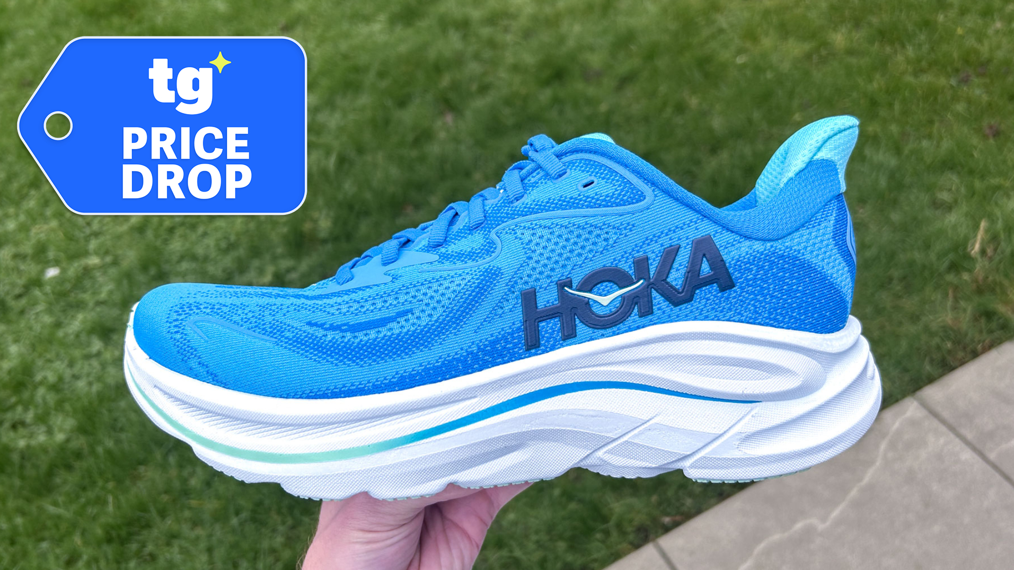 Hoka Clifton 10 sneaker held in hand