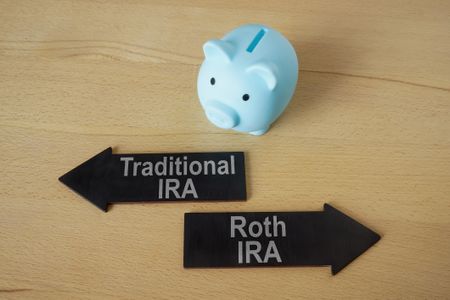 Piggy bank and arrows Traditional and Roth IRA.