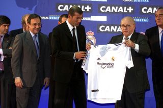 Zinedine Zidane receives a shirt from Real Madrid's honorary president Alfredo Di Stefano as president Florentino Perez watches on at the Frenchman's official presentation after signing from Juventus in July 2001.