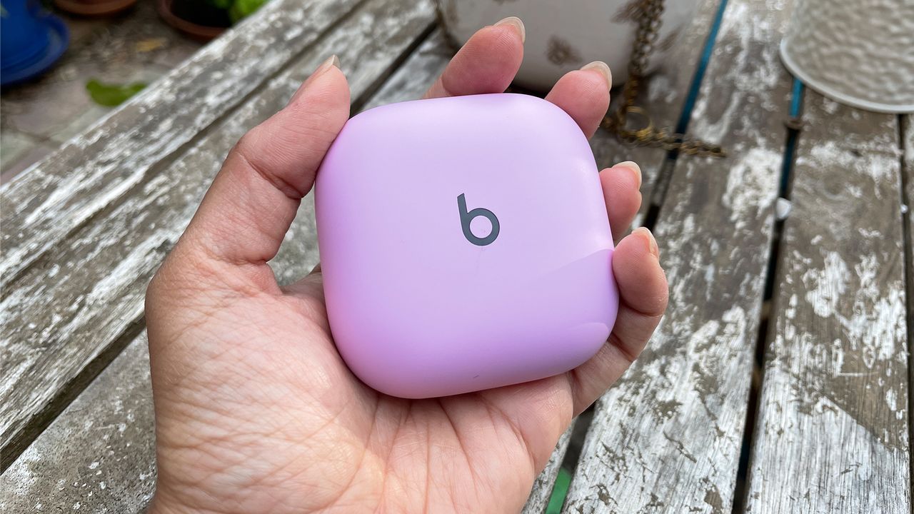 Beats Fit Pro pink case held in the hand.