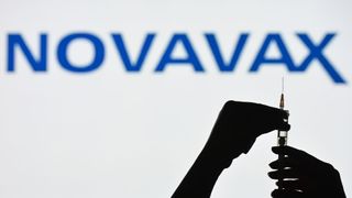 silouette of hands prepping a syringe for injection in front of white background with word "Novavax" written across it in blue