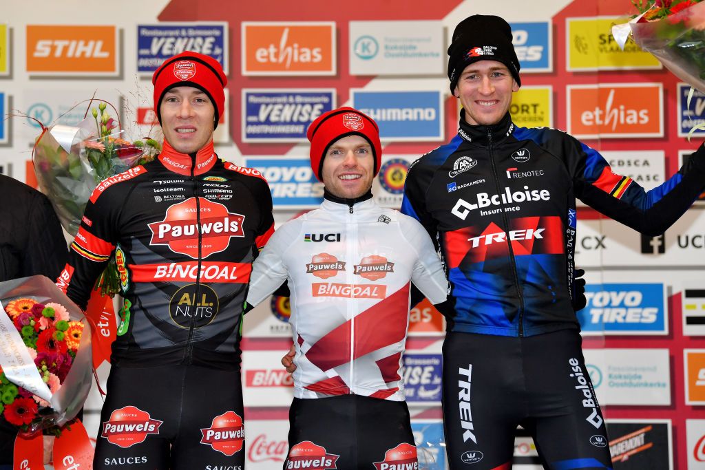 KOKSIJDE BELGIUM NOVEMBER 21 LR Laurens Sweeck of Belgium and Team Pauwels Sauzen Bingoal on second place race winner Eli Iserbyt of Belgium and Team Pauwels Sauzen Bingoal and Toon Aerts of Belgium and Team Baloise Trek Lions on third place pose on the podium during the podium ceremony after the 50th Koksijde UCI CycloCross Worldcup 2021 Mens Elite CXWorldCup on November 21 2021 in Koksijde Belgium Photo by Luc ClaessenGetty Images
