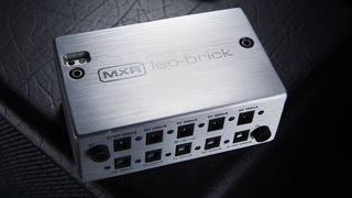 MXR Iso-Brick sat on top of a guitar amp