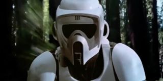 A scout trooper tries to outrun Luke and Leia on a speeder bike in Star Wars: Return of the Jedi