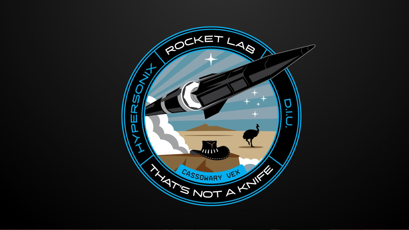 a circular mission patch showing a pointy black space vehicle in the center and the words &amp;quot;rocket lab,&amp;quot; &amp;quot;hypersonix&amp;quot; &amp;quot;diu&amp;quot; and &amp;quot;that's not a knife&amp;quot; around the outer edge