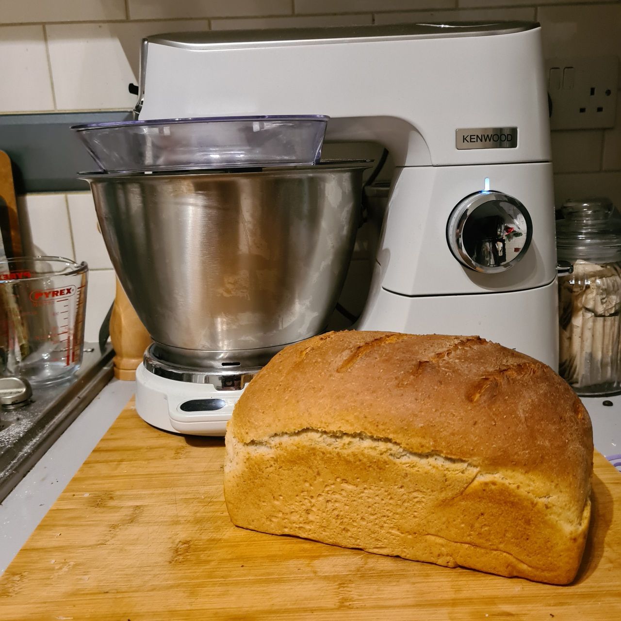 Kenwood Titanium Chef Baker next to freshly baked bread on wooden cutting board