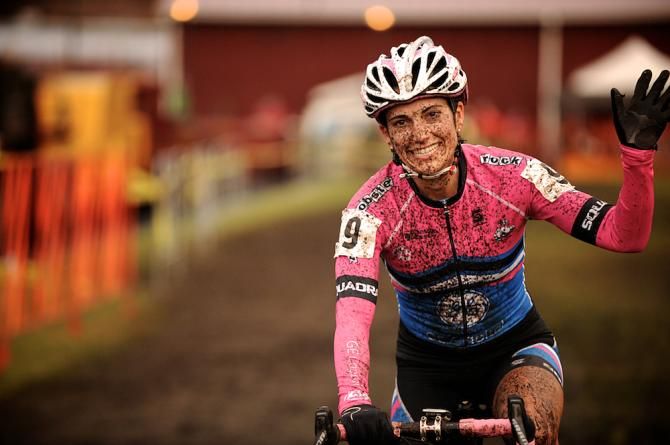 Courtney McFadden smiling as she crosses the line in third