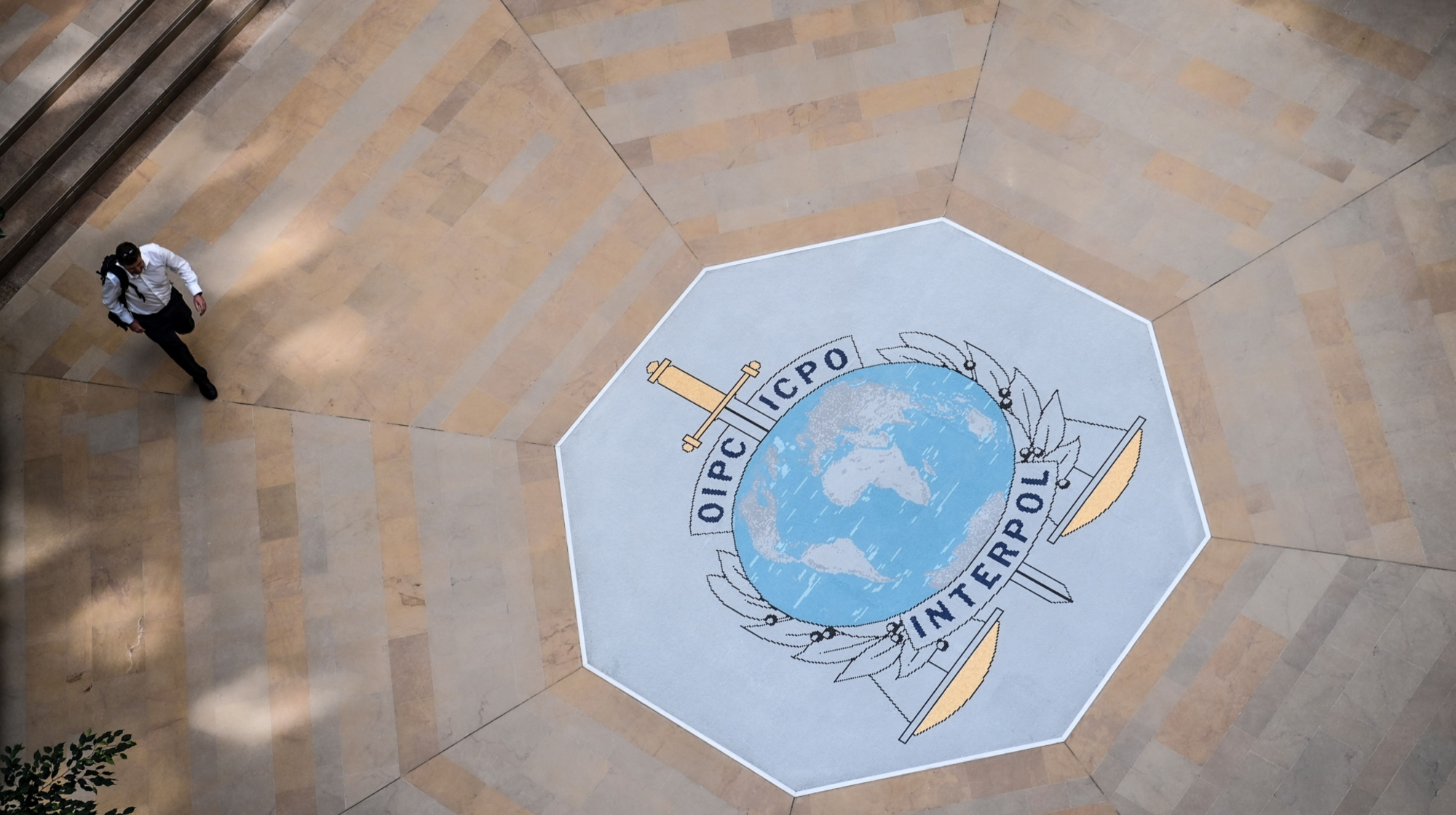 A employee walks in the hall of the International Criminal Police Organization headquarters, known as Interpol, in Lyon, eastern France, on September 5, 2023.