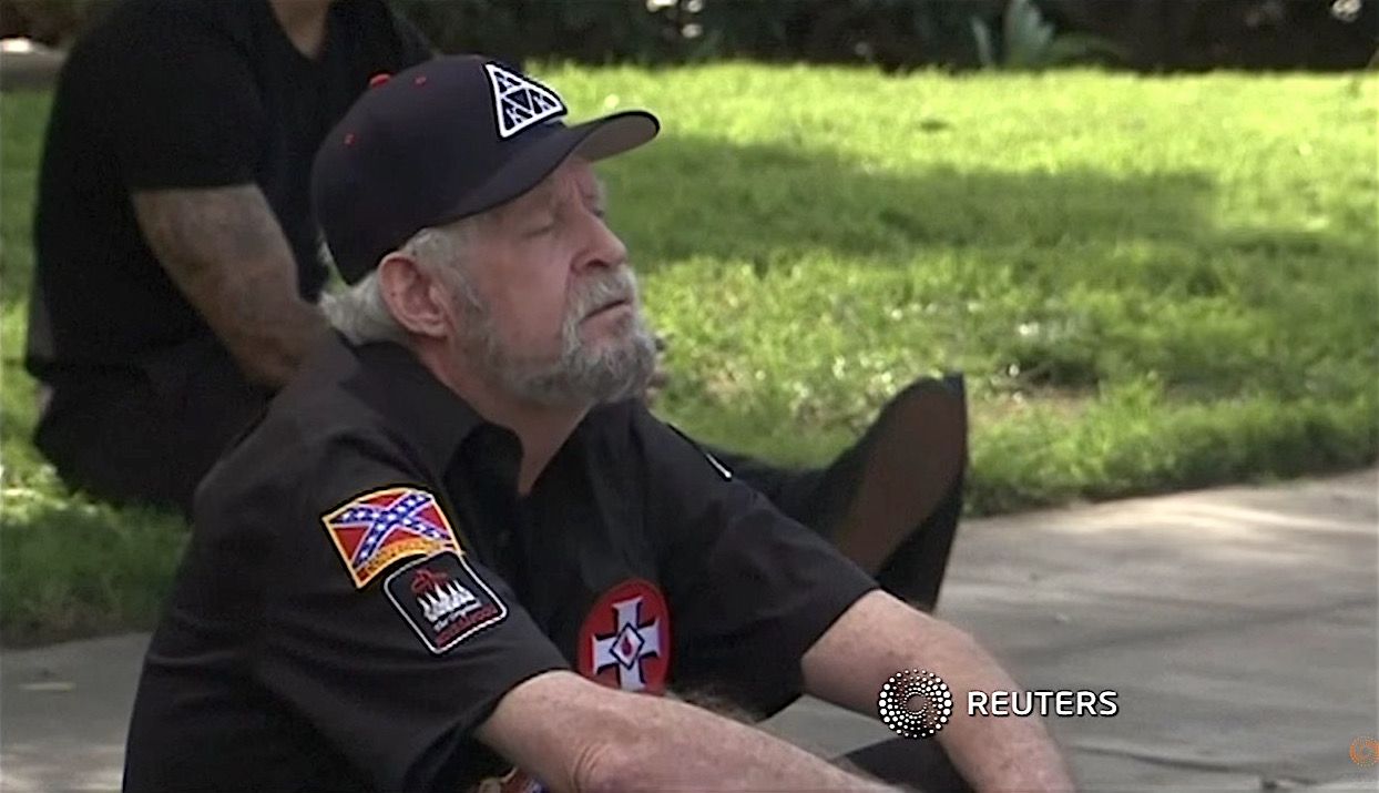 A member of the Ku Klux Klan, resting after a violent clash in Anaheim, California