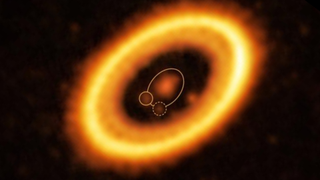 glowing orange rings, which indicate a young planetary system, against the blackness of space