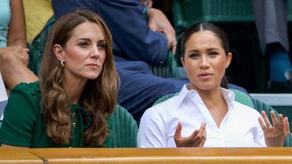 Catherine, Duchess of Cambridge sits with Meghan, Duchess of Sussex, and Pippa Middleton in the Royal Box on Centre Court ahead of the Ladies Singles Final between Simona Halep of Romania and Serena Williams of the United States on Centre Court during the Wimbledon Lawn Tennis Championships at the All England Lawn Tennis and Croquet Club at Wimbledon on July 13, 2019 in London, England.