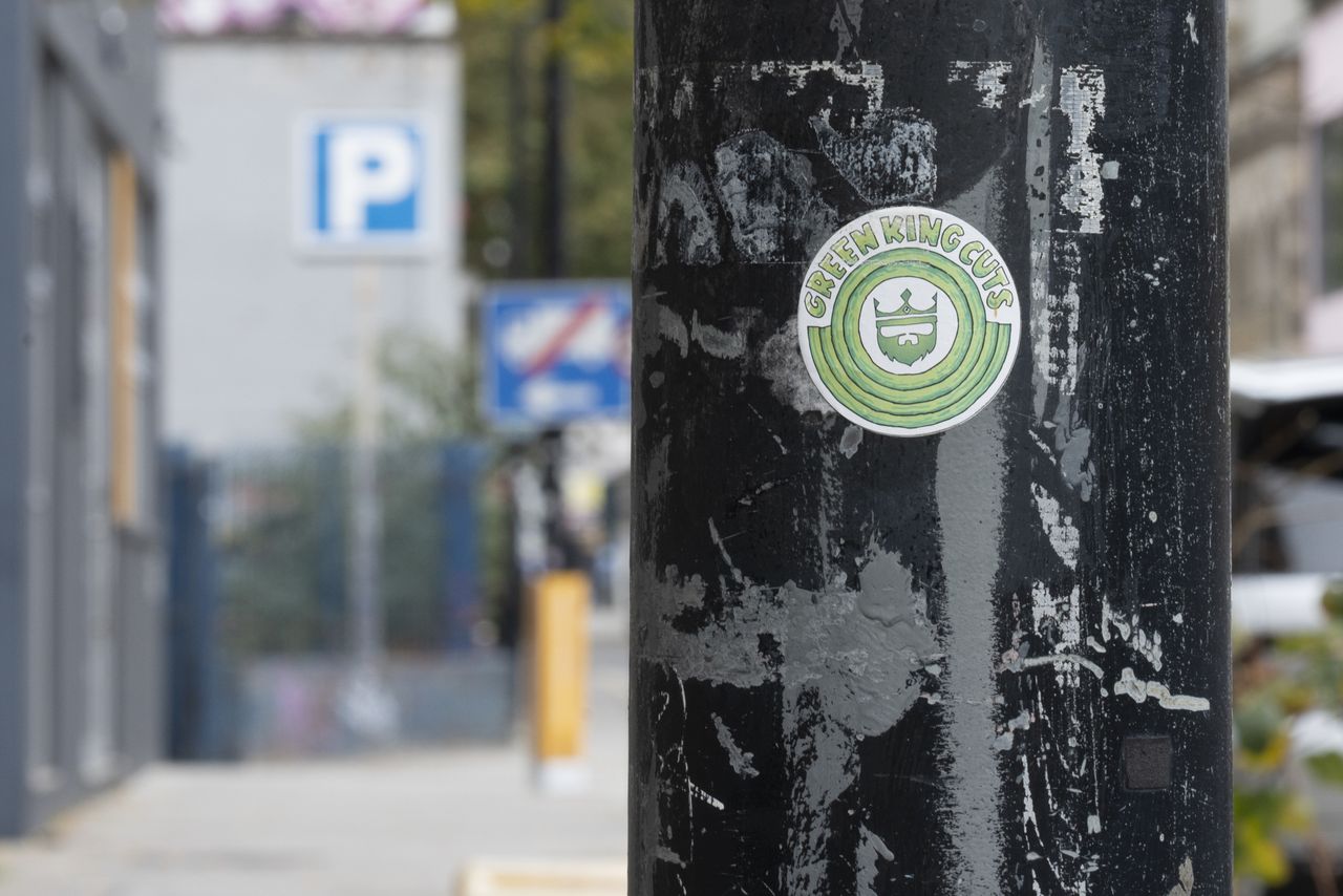 A sticker on the side of a streetlamp
