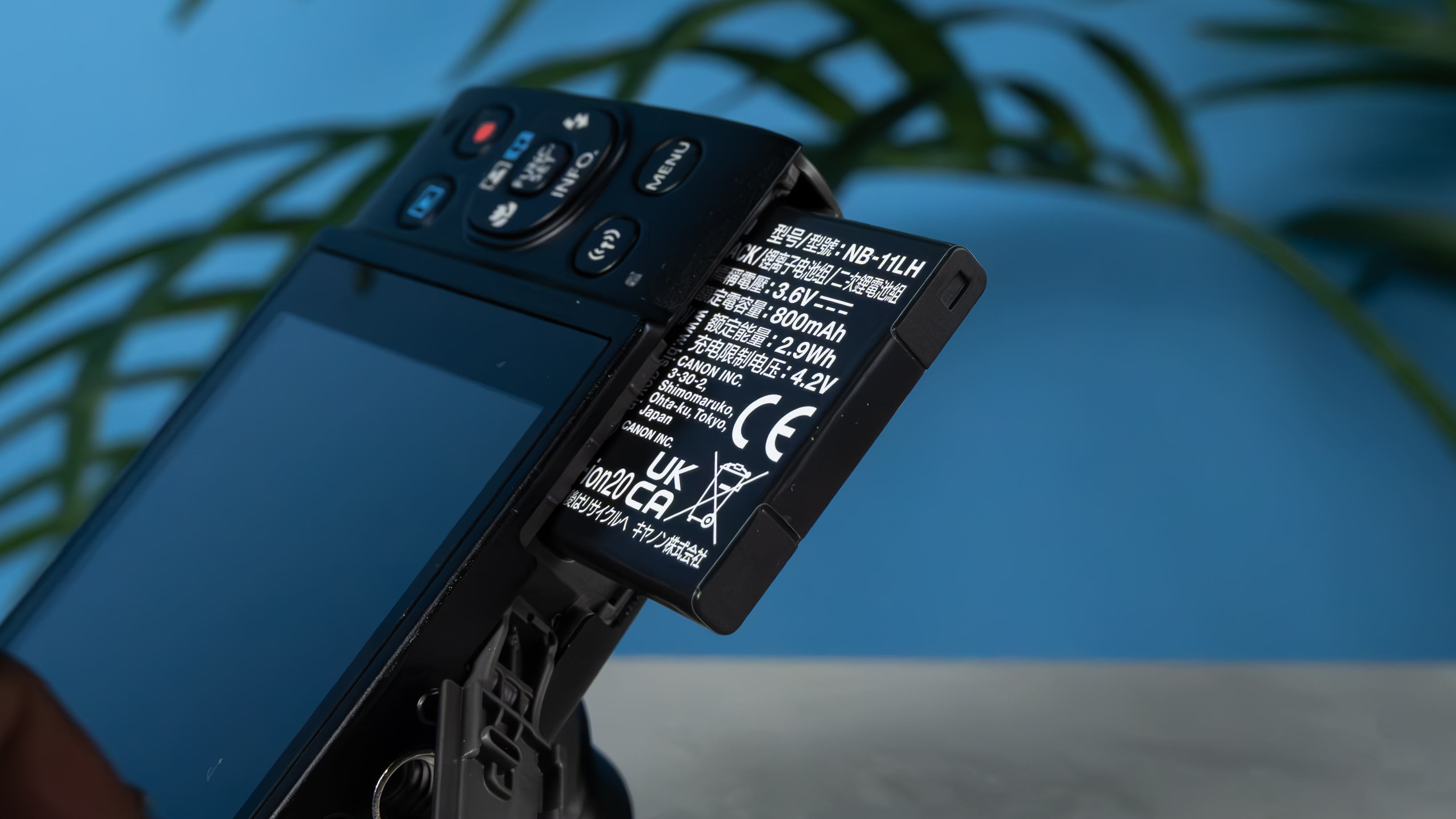 A black Canon PowerShot Elph 360 HS A or Canon PowerShot IXUS 285 HS A compact camera