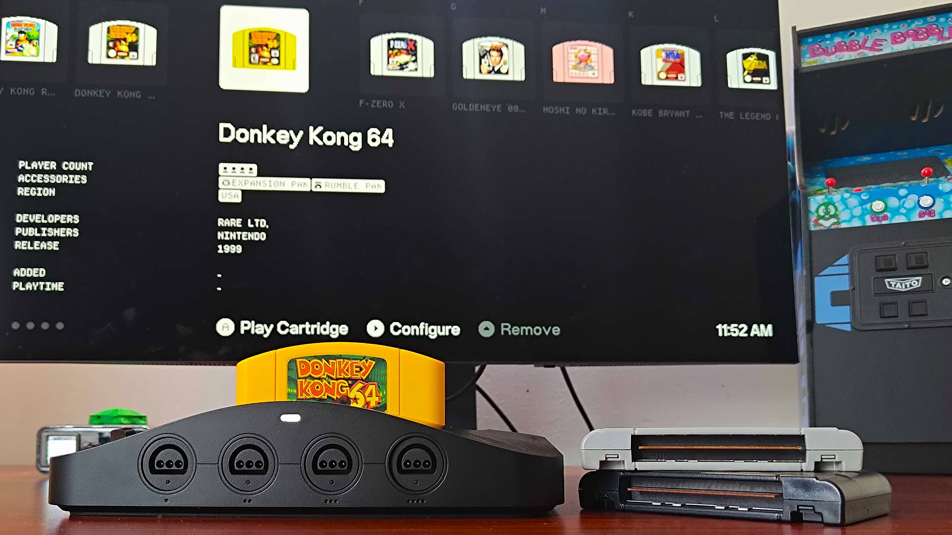 Analogue 3D connected to monitor with yellow Donkey Kong 64 cart inserted and matching library entry on screen.