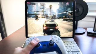 Cyberpunk 2077 played using GeForce Now on an iPad Pro 2021, with a PS5 DualSense controller in foreground