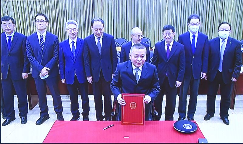 An image shared by the China National Space Administration (CNSA) shows director Zhang Kejian (front) during the signing of the memorandum of understanding between China and Russia to build a shared facility on the moon.