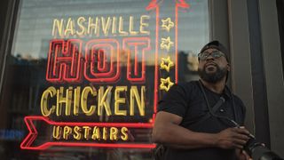 Promotional image of Tony Shepard by a neon-lit sign in Nashville for Adorama's Picture America