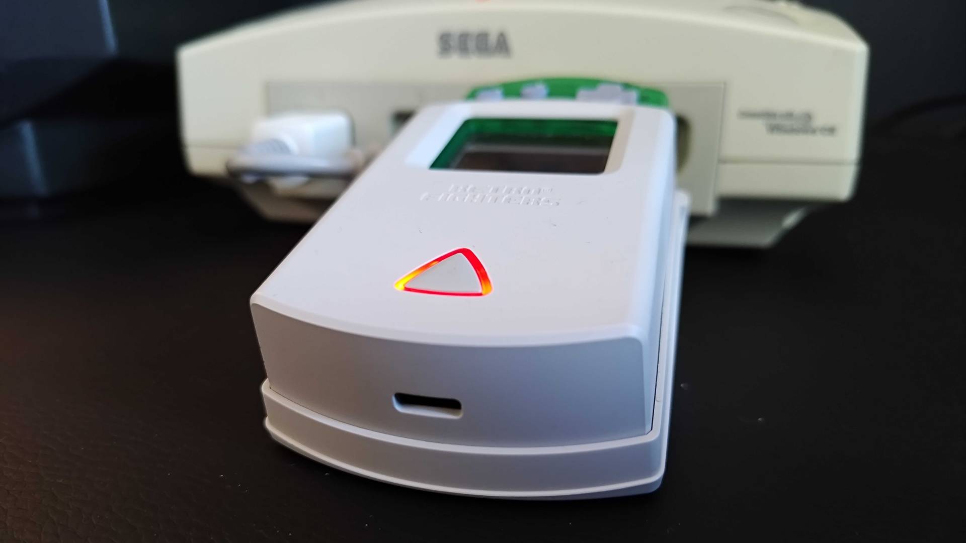 Close up of Retro Fighters StrikerDC cradle receiver with USB-C port at front.