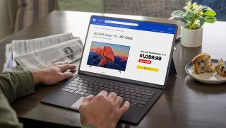 Person browsing the Best Buy website on a laptop about to buy a TV